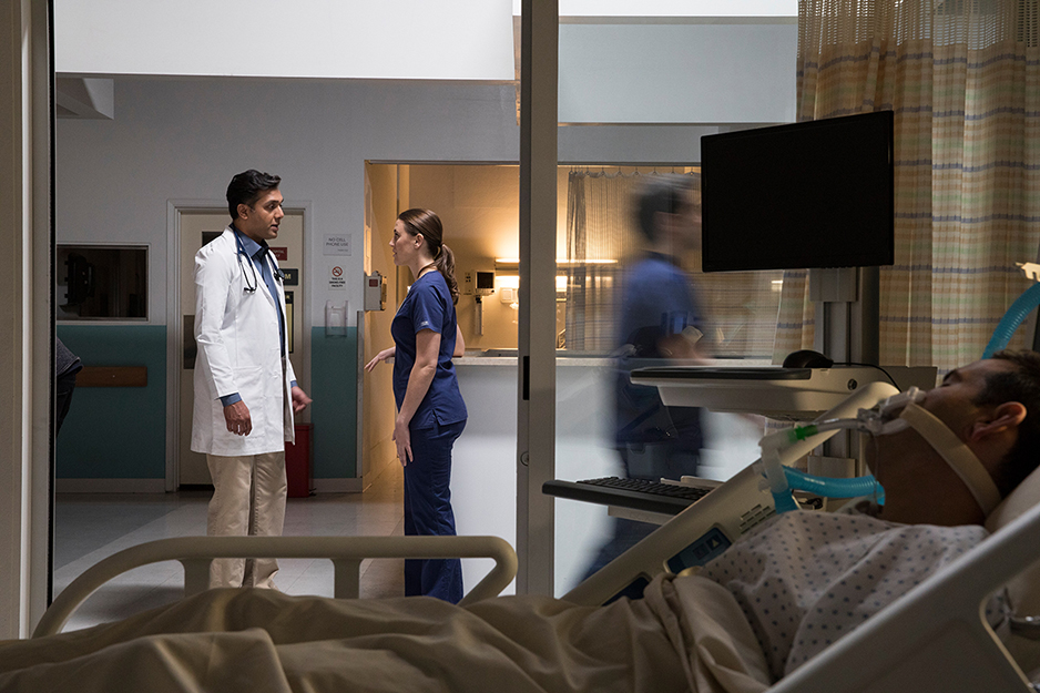 Doctor and nurse talking outside patient room